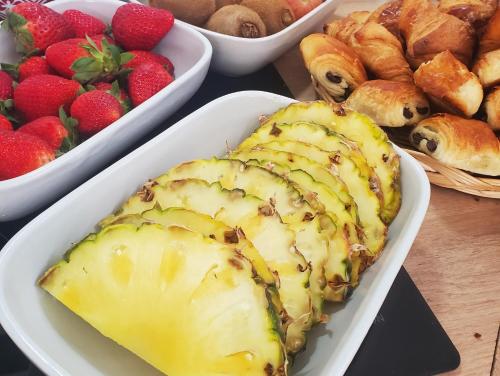 a table topped with plates of food and pastries at Cale 32 - Chambres d'hôtes in Saint-Jean-de-Monts