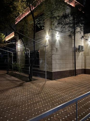 a basketball court in front of a building at night at Elite comfort City house in Samarkand