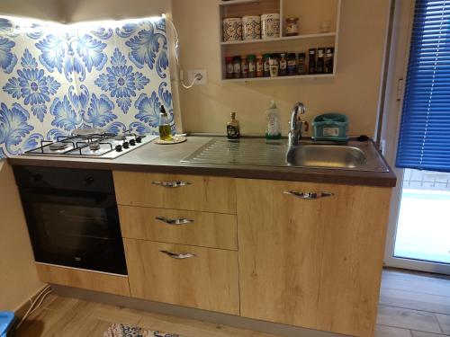 a kitchen with a sink and a stove at San vito 9 in Agrigento