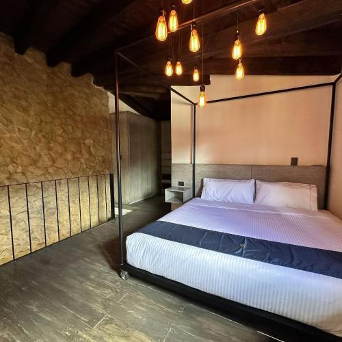 a bedroom with a large bed with a canopy at Hotel Pietro Santo in Santeagueda
