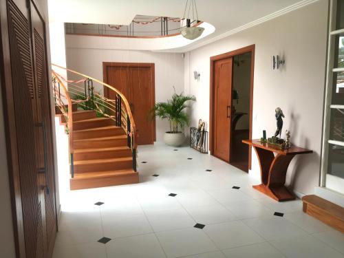 a hallway with a staircase and a floor with tiles at Casa Deco Hotel Boutique in Cochabamba