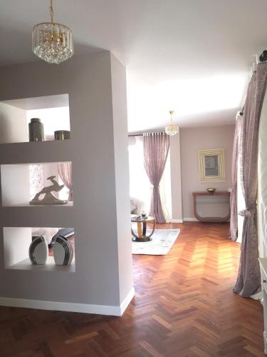 a living room with white walls and wooden floors at Casa Deco Hotel Boutique in Cochabamba