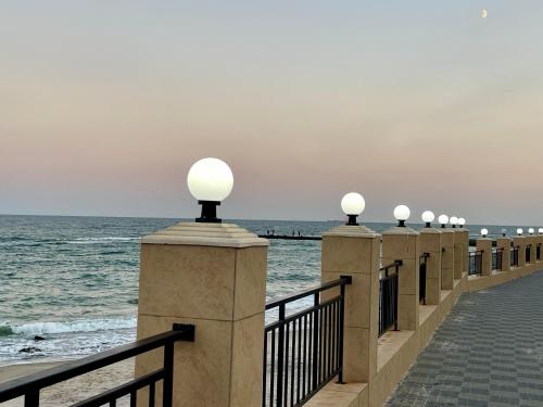 a row of lights on a pier near the ocean at Апартаменты у моря с панорамным видом Золотой Берег in Odesa