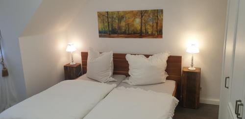 a bedroom with two beds and two lamps on tables at Ferienwohnung Villa Iris 1 in Bad Orb