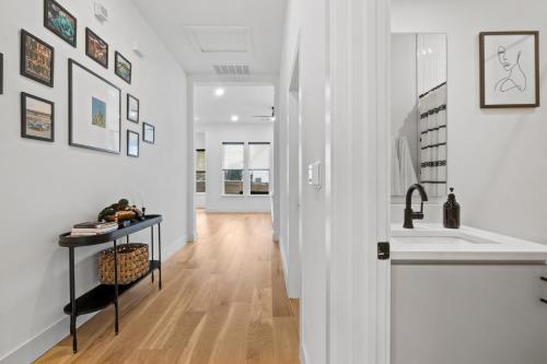 a hallway with a sink and a counter in a house at Rainey St Retreat - Cowboy Pool & Urban Chic in Austin