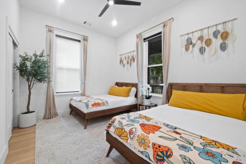 a bedroom with a bed and a couch and a window at Rainey St Retreat - Cowboy Pool & Urban Chic in Austin