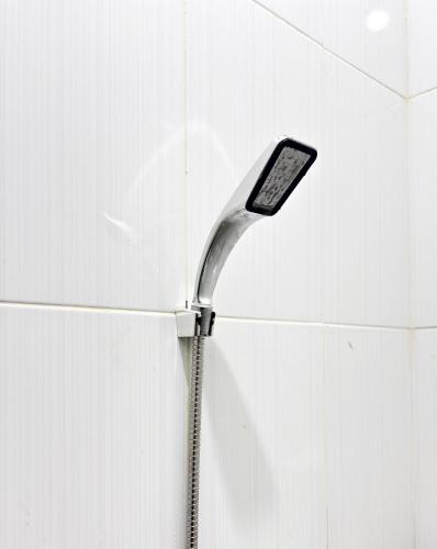 a cell phone on a spatula attached to a wall at Semarang Inn Syariah in Semarang