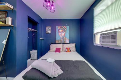 a blue bedroom with a bed with a painting on the wall at Pet-Friendly Fort Lauderdale Home 8 Mi to Beach! in Fort Lauderdale