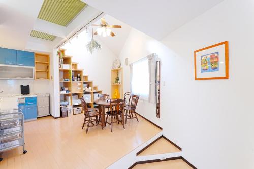 a kitchen and dining room with a table and chairs at LOISIR Kunitachi in Kunitachi