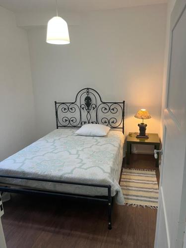 a bedroom with a bed and a table with a lamp at Casa 18 in Évora