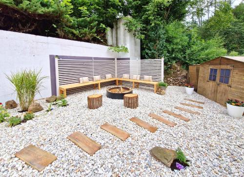 a backyard with a firepit and benches and a fire pit at ROMANTIK HOTEL ELEONORA in Tábor