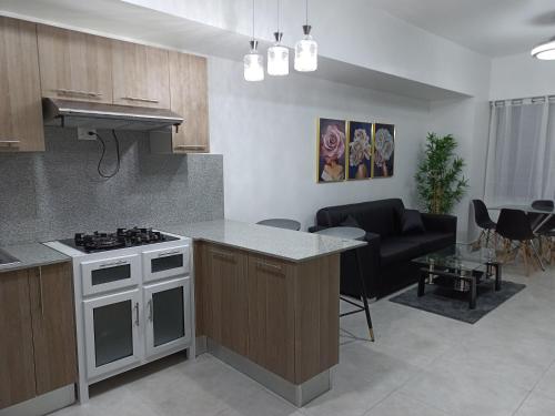a kitchen and living room with a stove and a couch at Boca del Mar III, apartamento 707 in Cuevas