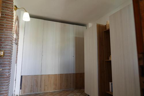 a room with a large white cabinet and a window at R-HOME Li Cuti in Catania