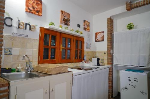 a kitchen with a sink and a refrigerator at R-HOME Li Cuti in Catania
