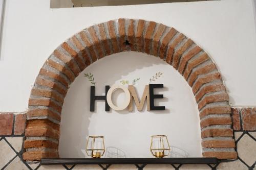 an archway with a love sign on a wall at R-HOME Li Cuti in Catania