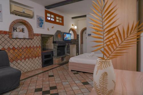 a room with a bedroom with a bed and a fireplace at R-HOME Li Cuti in Catania