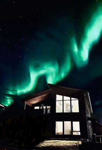 a building with the aurora in the sky at Villa Arctic in Tromsø