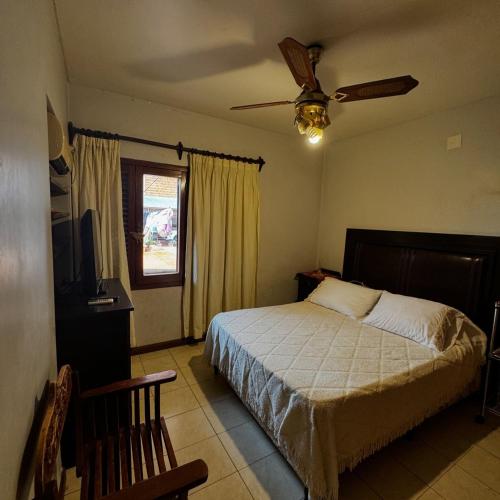 a bedroom with a bed and a ceiling fan at LA CASONA jn in Posadas