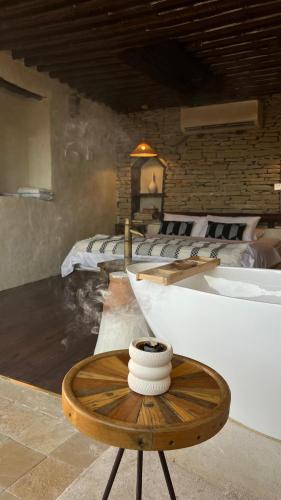 a room with two beds and a wooden table at نزل حارة المسفاة Harit AL Misfah Inn in Misfāh