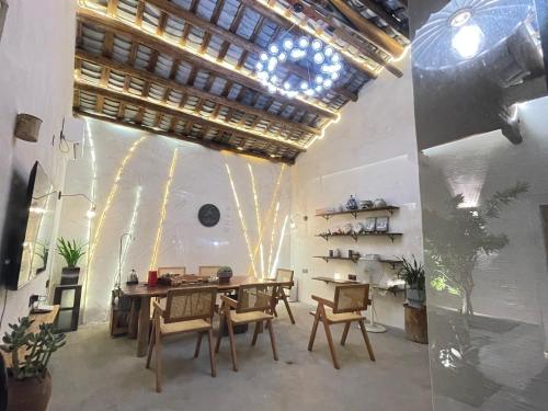 a dining room with a table and chairs at Waiting for the Blossoms B&B Tea House in Shantou