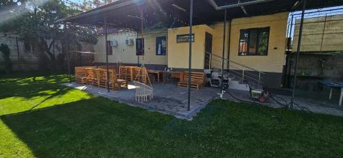 a patio with a table and chairs outside of a house at Kerege Guesthouse & Hostel in Bishkek