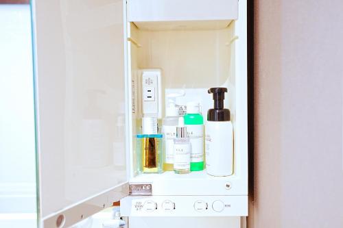 an open refrigerator with products in it at LOISIR Kunitachi in Kunitachi