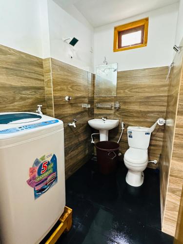 a bathroom with a toilet and a sink at Avanthika Holiday INN in Jaffna