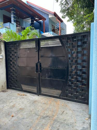 a black gate in front of a house at Avanthika Holiday INN in Jaffna