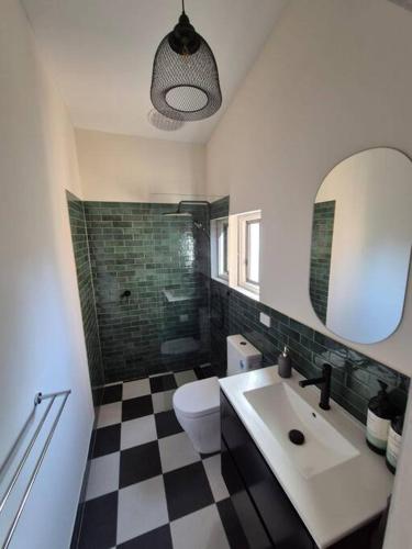 a bathroom with a sink and a toilet and a mirror at Charming! 3 Bed Garden by Beach in Largs