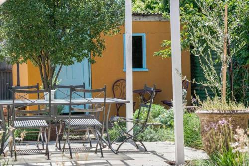 a patio with a table and chairs in a garden at Charming! 3 Bed Garden by Beach in Largs