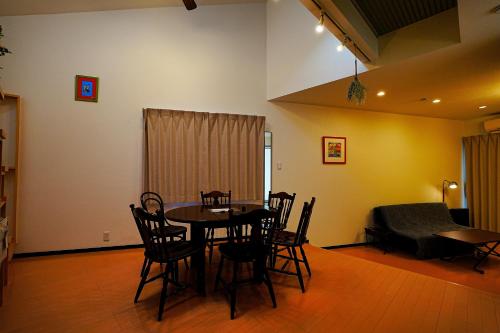 a dining room with a table and chairs at LOISIR Kunitachi in Kunitachi
