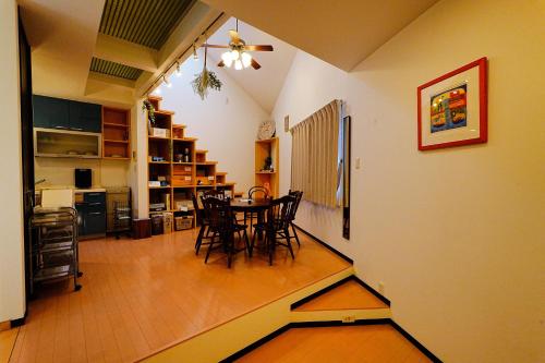 a dining room and kitchen with a table and chairs at LOISIR Kunitachi in Kunitachi