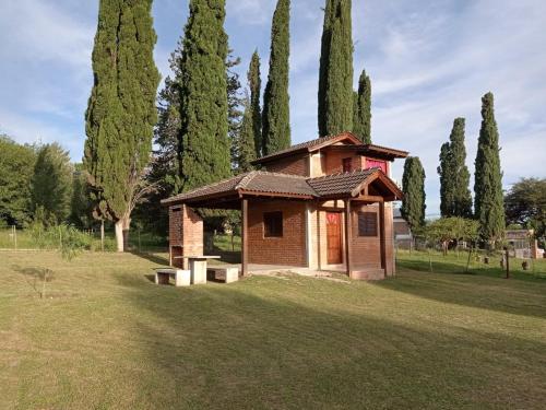 a small building in a field with trees at Un lugar en el Mundo in Villa Amancay