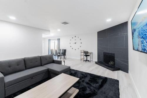 a living room with a couch and a fireplace at 5Mins to Fremont 10Mins to Strip! Sleeps 8! in Las Vegas