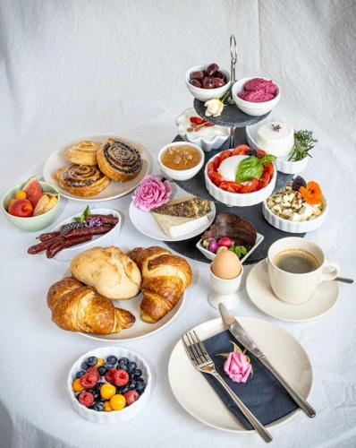 a table with a bunch of breakfast foods and coffee at Maison Da Silva in Oberderdingen