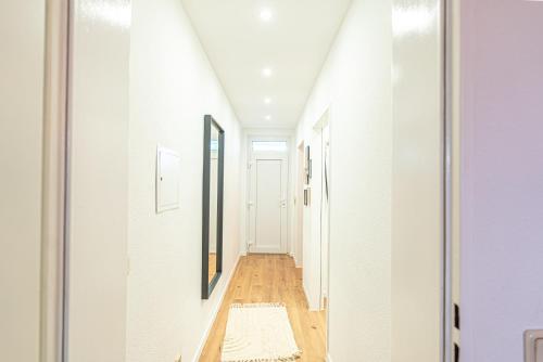 a hallway of a house with white walls and wood floors at Apartment Wesseling Zentrum in Wesseling