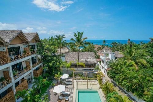 an aerial view of a resort with a swimming pool and the ocean at Witari Hotel Boutique in San Francisco