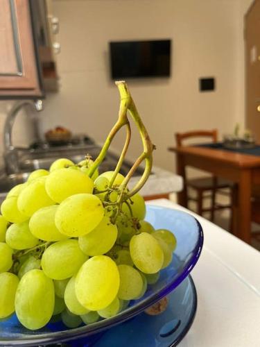 a bowl of green grapes sitting on a table at Palazzo Giardinello in Trapani