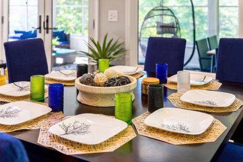 a table with plates and bowls on top at Mt Views - Sauna - Hot Tub - Adulting - Family Fun in Massanutten