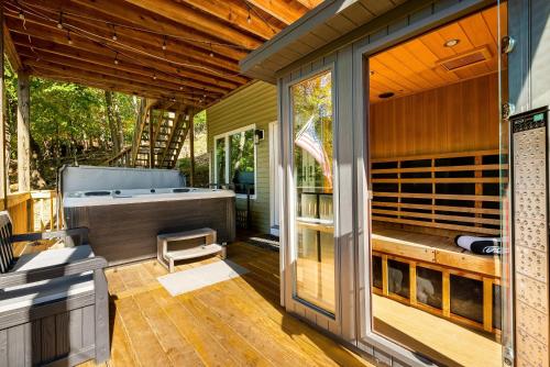 a porch with a hot tub and a deck with at Mt Views - Sauna - Hot Tub - Adulting - Family Fun in Massanutten