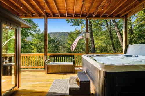 a large outdoor tub in a deck with a view at Mt Views - Sauna - Hot Tub - Adulting - Family Fun in Massanutten