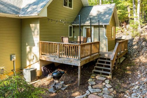 a house with a deck and a grill next to it at Mt Views - Sauna - Hot Tub - Adulting - Family Fun in Massanutten