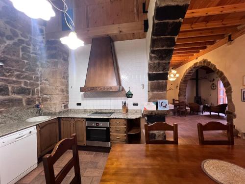 a kitchen with a stove top oven in a room at Sitjar Casa Rural in Cabanes
