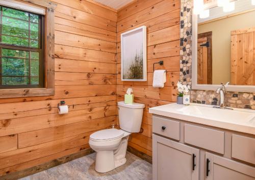 a bathroom with a toilet and a sink at Veteran Host Pets Allowed Sleeps 4 No Minimum Nights in Pigeon Forge