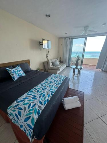a bedroom with a bed and a view of the ocean at Loft Holp in Cancún