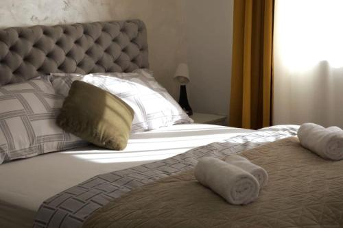 a bedroom with a bed with towels on it at Airport Studio Stefan in Belgrade