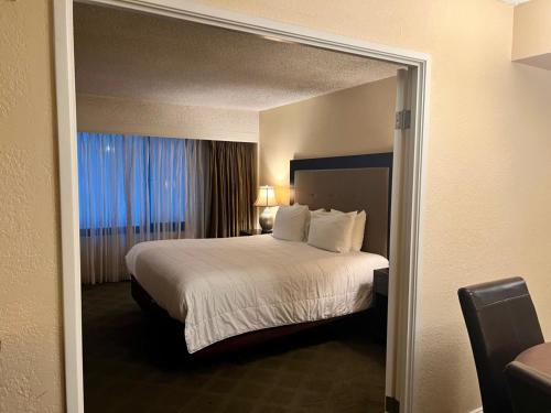 a hotel room with a bed and a large window at Jockey Resort Suites Center Strip in Las Vegas