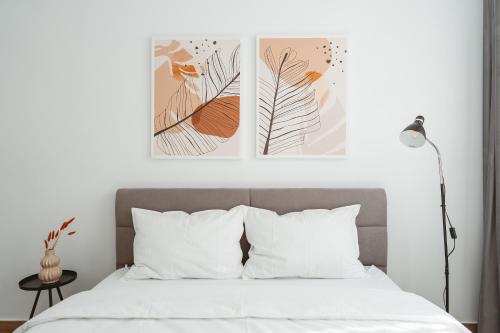 a bedroom with two posters on the wall and a bed at The Palm 2 Apartment - family friendly, central, self check-in in Oradea