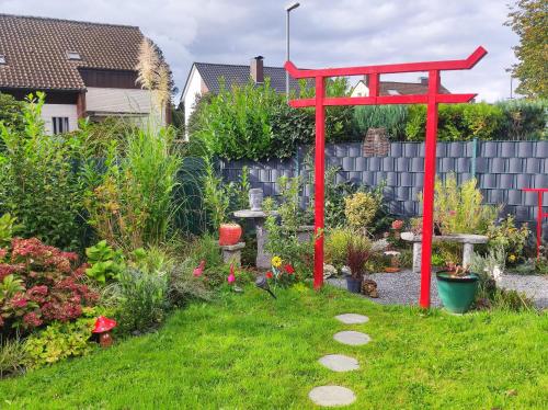 a red structure in the middle of a garden at Uni-nähe Unterkunft mit Garten in Bochum