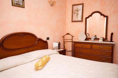 a bedroom with two beds and a dresser and a mirror at Casa Ragno Corchiano in Corchiano